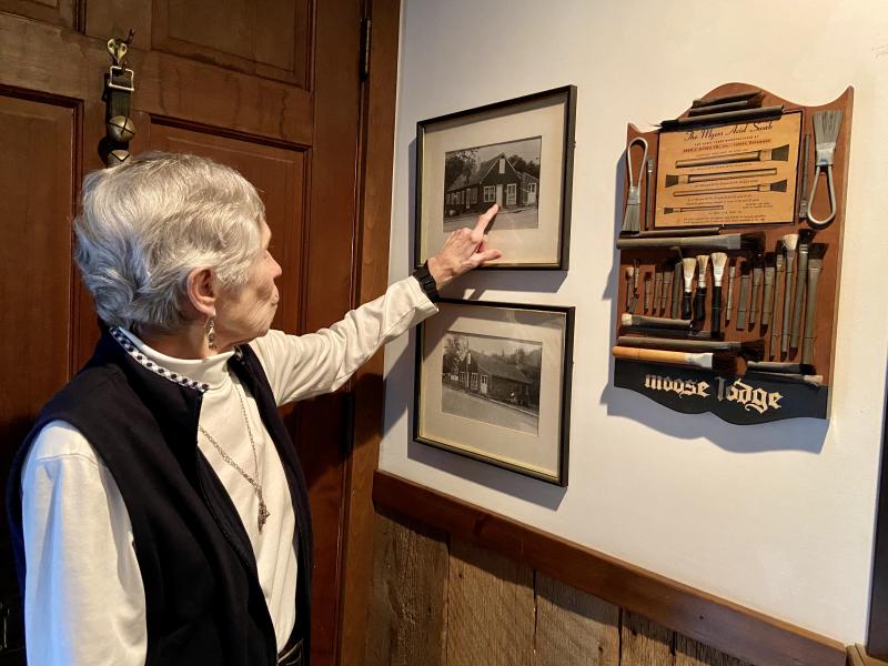 Lewes artist Barbara Petterson displays old photos of the original brush factory on McFee Street in Lewes and a collection of brushes she found while converting the old factory into a home. ELLEN DRISCOLL PHOTOS